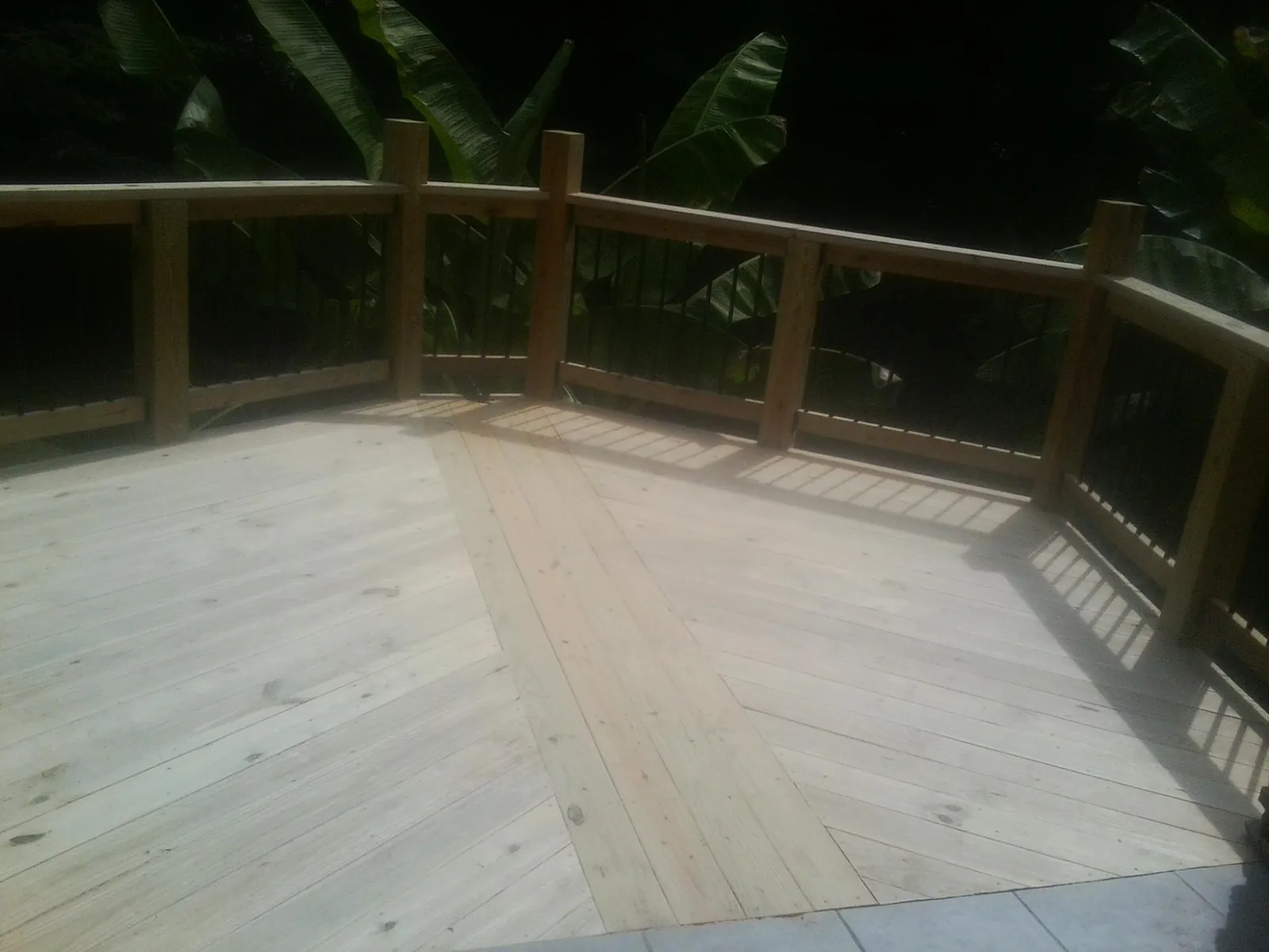 New wood deck and railing built off the back of a home in Valparaiso